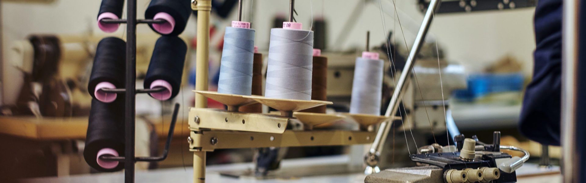 Image of a lot of coils with a threads at the sewing workshop. Close-up image of a lot of coils with a threads at the sewing workshop.